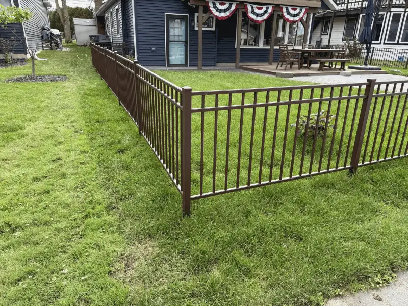 Black aluminum ornamental fence enclosing backyard patio near home, Northern Indiana installation