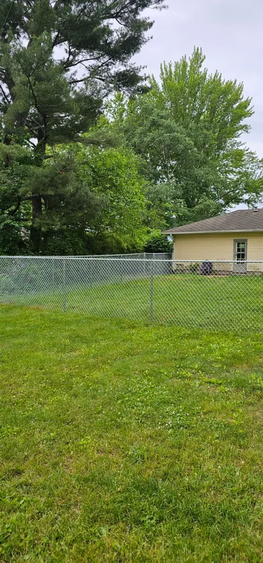 Chain link fence enclosing residential backyard, Northern Indiana