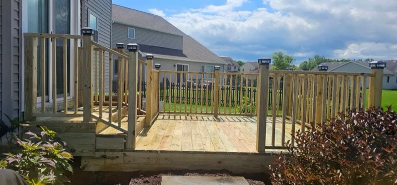 Pressure-treated wood deck with steps and full railing, Northern Indiana deck build